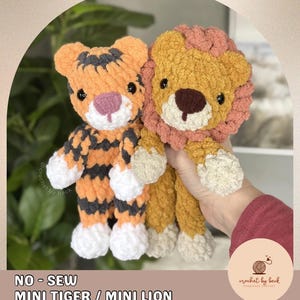 May include: Two crocheted stuffed animals: a tiger and a lion. The tiger is orange and black, while the lion is tan with a pink mane. The text "NO - SEW MINI TIGER / MINI LION DIGITAL DOWNLOAD CROCHET PATTERN" is at the bottom.