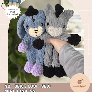 May include: Two crocheted mini donkeys, one blue and one gray, are held in a person's hand. The blue donkey has purple feet and a black patch. The gray donkey has black feet and a black mane. The image includes text that says "NO - SEW / LOW - SEW MINI DONKEYS DIGITAL DOWNLOAD CROCHET PATTERN."