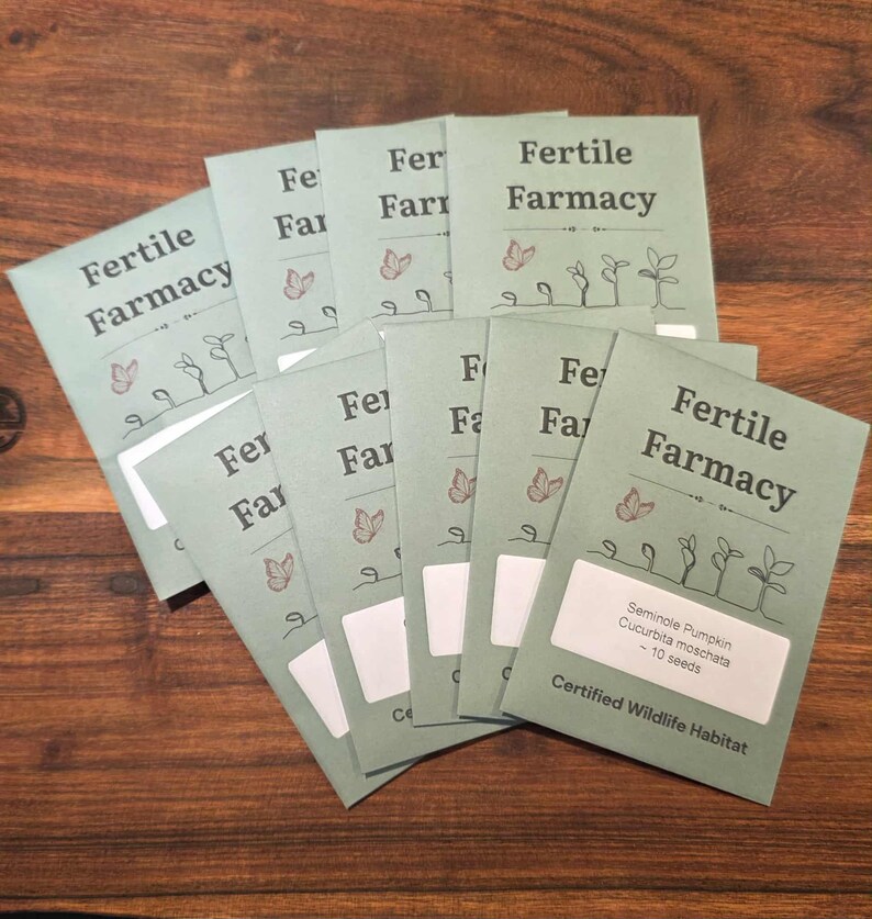 May include: A collection of seed packets with the text "Fertile Farmacy" in a light green color. The packets feature illustrations of butterflies and sprouts. One packet has a label that reads "Seminole Pumpkin Cucurbita moschata - 10 seeds."