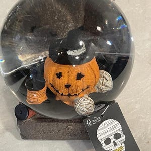 Spooky Halloween snow globe, interior features a pumpkin wearing a Witch’s Hat. Shake for a snowfall of black bats! Creepy Halloween gift!