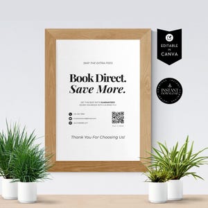 May include: A framed poster with the text "Book Direct. Save More." in a bold, black font. The poster also includes contact information and a QR code. The frame is made of light brown wood. The poster is surrounded by small potted plants.