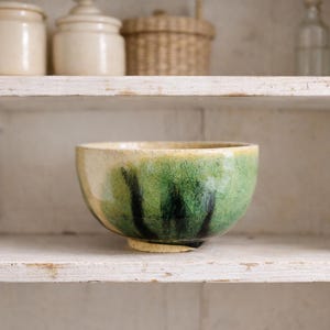 May include: A trio of ceramic mugs with a speckled, matte finish in cream, light grey, and dark grey. Each mug features a simple, minimalist design, ideal for tea or coffee.