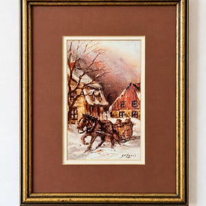 May include: An oil painting in a gold and black frame depicting a horse-drawn sleigh in a snowy village scene. The painting features a brown horse pulling a sleigh with figures past houses with red and yellow walls under a winter sky.