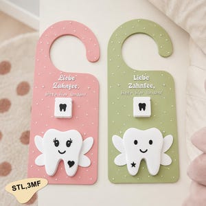 May include: Two door hangers in pink and sage green, each featuring white polka dots and the German text 'Liebe Zahnfee, bitte hier landen!'. Each hanger includes a small white square with a black tooth icon and a larger white tooth character.