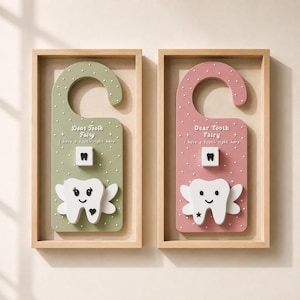 Two pastel-colored 3D printed Tooth Fairy door hangers featuring raised stars, playful text, sliding tooth holders, and large winged tooth pockets. One design is sage green and the other blush pink, both styled with matte white details and designed as decorative kids room door signs.