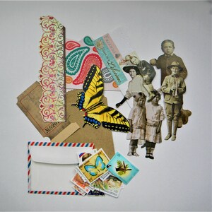 May include: A collection of paper ephemera including a yellow and black butterfly cutout, vintage black and white photographs of children, a decorative border strip, a brown ticket, a small envelope, and a pile of colorful postage stamps.