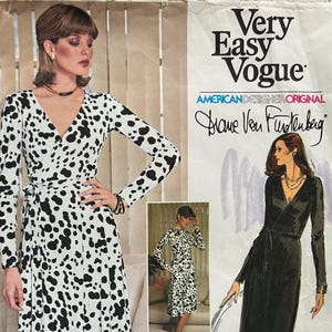 May include: A vintage sewing pattern from Very Easy Vogue featuring a wrap dress design. The pattern includes a black and white spotted dress with long sleeves and a tie waist. The pattern is designed by Diane Von Furstenberg. The pattern number is 1548.