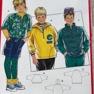 May include: A Burda sewing pattern packet, featuring illustrations of children's clothing designs. The packet displays a green and yellow floral jacket, a yellow hooded jacket, and a green and teal jacket. The text "burda 5576" is at the top.