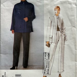 May include: A Vogue American Designer sewing pattern envelope by Oscar de la Renta, number 2188, for sizes 12-14-16. The front displays a photograph of a dark blue jacket and dark trousers, alongside a sketch of the same outfit in white.