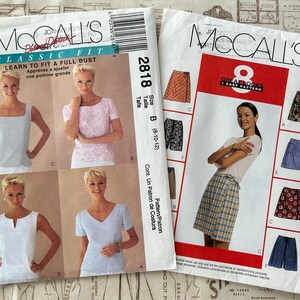 May include: Two McCall's sewing pattern envelopes. One features a woman in various tops, the other a woman in a skirt. The first pattern is labeled "Classic Fit" and "Learn to Fit a Full Bust". The second pattern is labeled "8 Great Looks".