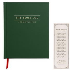 May include: A dark green hardcover reading journal with the gold text THE BOOK LOG A READING JOURNAL on the front cover and a red ribbon bookmark. Beside it is a tall, narrow cream-colored bookmark with the text BOOK MARKED SHELF STATS.