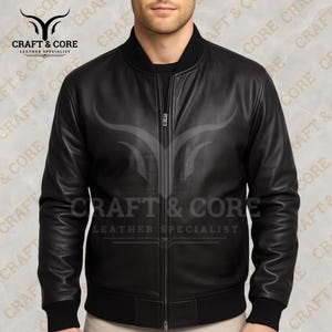 Black Nappa leather bomber jacket for men with ribbed collar, cuffs, durable zippers, and internal pockets. Made from 100% genuine leather, perfect for motorcycling, outdoor adventures, and casual wear. png