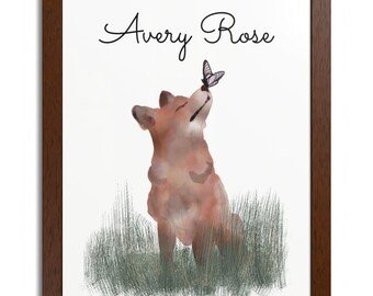 May include: A framed art print featuring a watercolor illustration of a fox looking up at a butterfly. The print includes the text "Avery Rose" in cursive script. The fox is sitting in a patch of green grass against a white background.