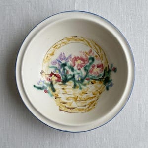 May include: A white ceramic mug with a black handle and the text "But First, Coffee" in a handwritten style. The mug is on a white surface. The mug is 4 inches tall.