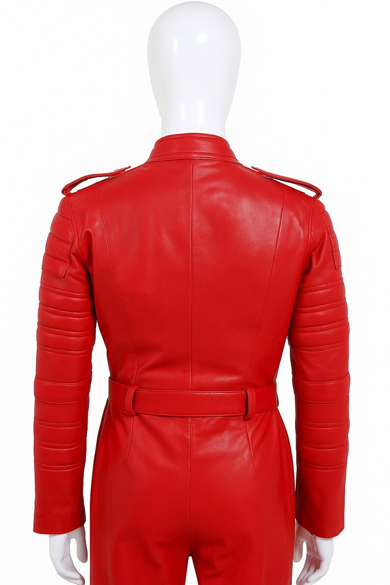 K&ouml;nnte beinhalten: Eine leuchtend rote Lederjacke mit einem Tailleng&uuml;rtel und gesteppten Details an Schultern und Armen. Die Jacke hat einen Stehkragen und Schulterklappen. Die R&uuml;ckansicht zeigt den ma&szlig;geschneiderten Schnitt und das Design des Kleidungsst&uuml;cks.