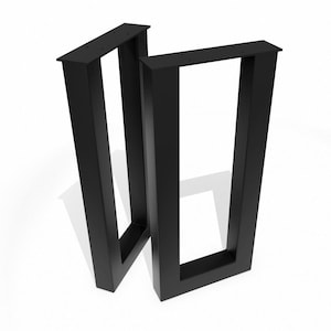 May include: Two black metal table legs. Each leg has a rectangular frame with a flat top and a square base. The legs are designed to be mounted to a tabletop. The legs are made of a sturdy metal.
