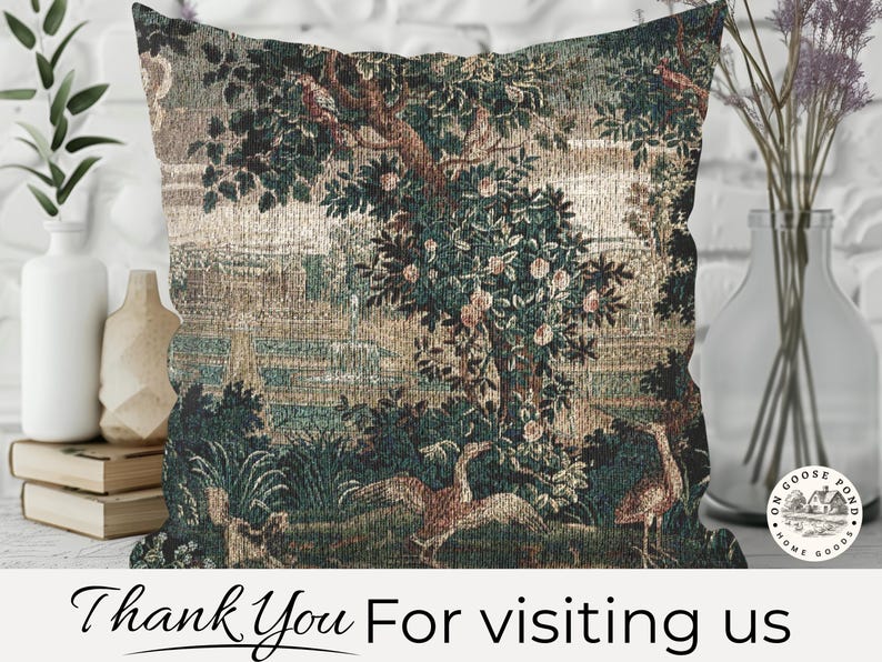 May include: Square cushion with a tapestry design depicting a landscape with trees, birds, and water features. The colour scheme includes green, brown, and beige tones. The cushion is made of woven fabric and is designed for home decor.