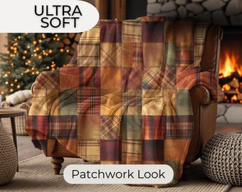 May include: A patchwork-style blanket in shades of brown, orange, and red, draped over a brown leather armchair. The blanket features a variety of plaid and solid fabric squares. The text "ULTRA SOFT" and "Patchwork Look" are visible.