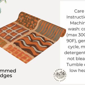 Op de afbeelding: Een rechthoekige stoffen loper met een patchworkontwerp van oranje, bruine en cr&egrave;mekleurige patronen, waaronder ruiten, chevron en bloemmotieven. De tekst luidt: Care Instructions Machine wash: cold (max 30C or 90F), gentle cycle, mild detergent; Do not bleach; Tumble dry: low heat. Hemmed Edges.
