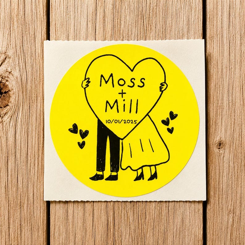 May include: A circular yellow sticker featuring a black line drawing of two figures holding a large heart. The heart contains the text Moss + Mill and the date 10/01/2025. Several small black hearts are scattered around the figures on the yellow background.