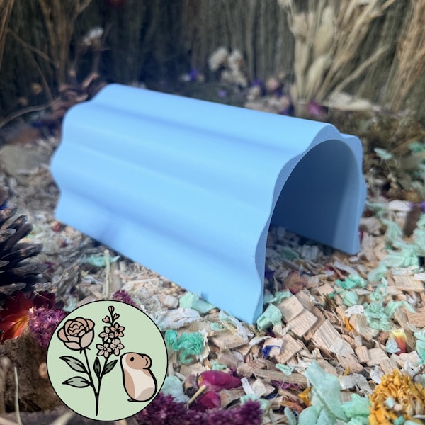 May include: A light blue, arched tunnel hideout for small pets with a corrugated, wavy exterior surface. The structure is open on both ends and features a smooth, matte finish, providing a simple, functional shelter for small animals.