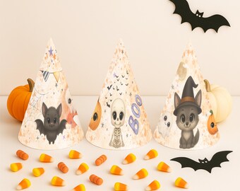 May include: Three Halloween-themed party hats with illustrations of a bat, skeleton, and a wolf wearing a witch hat. Orange pumpkins and candy corn are scattered around the hats. Black bat cutouts are also present.