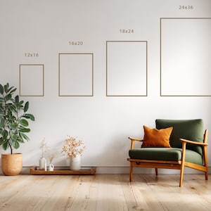 May include: Interior scene with framed art prints in sizes: 30x41 cm, 41x51 cm, 46x61 cm, and 61x91 cm. A green armchair with an orange cushion is present, along with potted plants and a wooden floor.