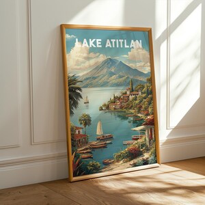 May include: A framed print of Lake Atitlan, depicting a tranquil lake scene with boats, verdant foliage, and a distant volcano. The artwork has a vintage travel poster style, with the words "LAKE ATITLAN" at the top.