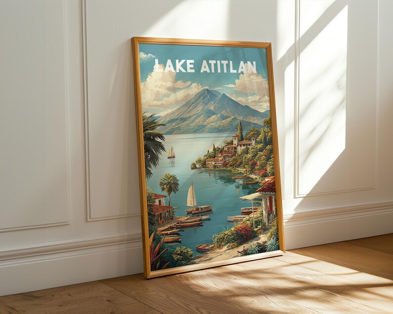 May include: A framed print of Lake Atitlan, depicting a tranquil lake scene with boats, verdant foliage, and a distant volcano. The artwork has a vintage travel poster style, with the words "LAKE ATITLAN" at the top.