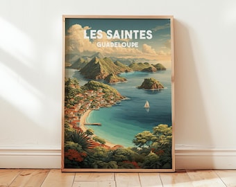 May include: A framed art print featuring a coastal landscape of Les Saintes, Guadeloupe. The artwork depicts a bay with turquoise water, lush green hills, and a small sailboat. The print includes the text "LES SAINTES GUADELOUPE" in a stylized font.
