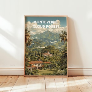 May include: Framed art print of the Monteverde Cloud Forest. The artwork depicts a lush, green landscape with a mountain range in the background. The text "MONTEVERDE CLOUD FOREST" is displayed at the top. Palm trees and buildings are also visible.