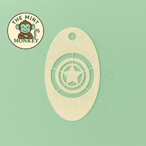 May include: Cream-coloured, oval-shaped stencil with a star and concentric circles design. The stencil has a small hole at the top for hanging. The Mint Monkey logo is in the upper left corner, featuring a monkey.