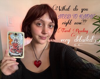 May include: A person holding a tarot card with an illustration of a figure in red and blue. The card is labeled with the number one. Text on the wall reads "What do you NEED TO KNOW right now?? Tarot Reading very detailed."
