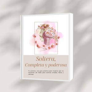May include: A book cover featuring a watercolour illustration of a woman in a hat holding flowers, surrounded by pink floral accents. The title "Soltera, Completa y poderosa" is displayed in elegant typography.