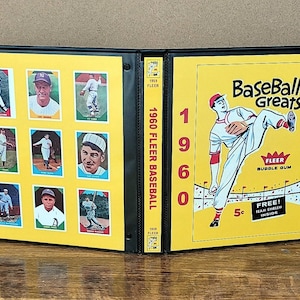 May include: A black binder displaying a 1960 Fleer Baseball card set. The yellow pages feature baseball cards and the text "Baseball Greats" with a baseball player illustration. The binder spine reads "1960 Fleer Baseball".