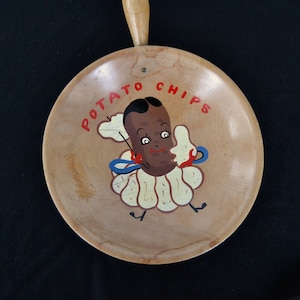 May include: A vintage wooden serving tray with a handle. The tray features a cartoon potato chip character with a smiling face, wearing a ruffled collar and holding a chip. The words "POTATO CHIPS" are written in red above the character.