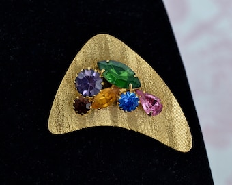 Vintage Boomerang Brooch Made of Gold Tone Metal with Rhinestones