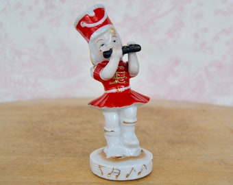 Vintage Ceramic Marching Band Girl Figurine with Red Costume and Gold Music Notes, Repainted and Made in Japan