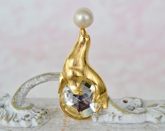 Vintage Seal on Plastic Rhinestone Ball and Balancing a Faux Pearl by Trifari