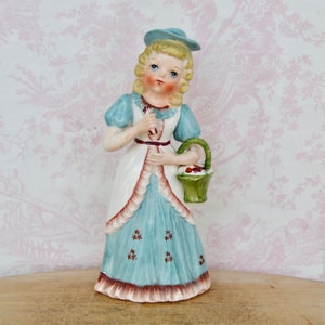 Vintage Ceramic Figurine of Woman with Small Vase and Basket