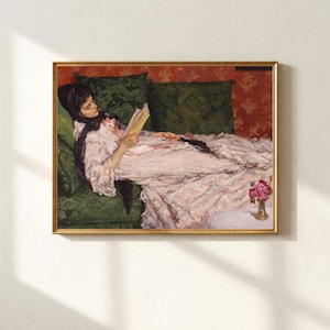 May include: A white ceramic mug with a black handle and the text "But First, Coffee" in a bold, black font. The mug is set against a blurred background, suggesting a cozy setting.