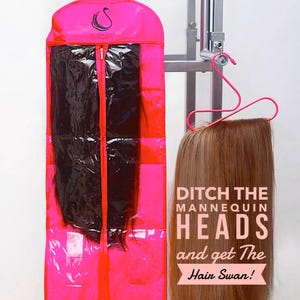 May include: A vibrant pink garment bag containing a black hair extension, and a light brown hair extension suspended on a pink hanger. Text reads "Ditch the Mannequin Heads and get The Hair Swan!"