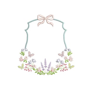 May include: An embroidered floral frame with a light blue border and a bow at the top. The frame is decorated with flowers, butterflies, and berries in shades of pink, purple, and green.