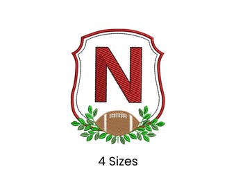 May include: Embroidered design featuring the letter "N" in red, set within a white and red shield shape. A football and green leaves are at the bottom. The text "4 Sizes" is below the design.