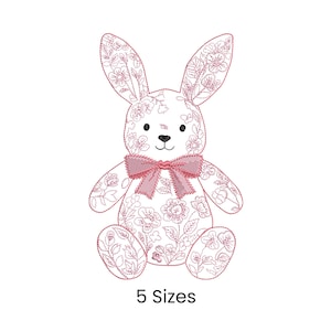 May include: A pink floral bunny design with a bow, black eyes, and the text "5 Sizes". The bunny is sitting upright with its ears perked up. The floral pattern is a delicate design.
