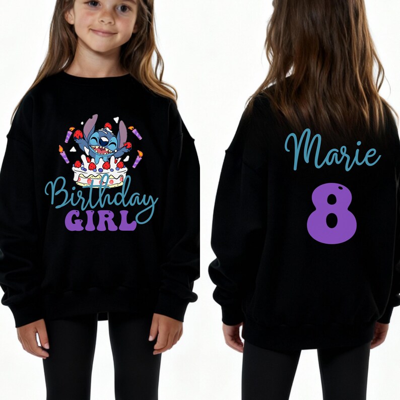 Puede incluir: Sudadera negra con un gr&aacute;fico colorido que presenta un personaje de dibujos animados, una tarta de cumplea&ntilde;os y las palabras "Birthday Girl". La parte trasera de la sudadera tiene el nombre "Marie" y el n&uacute;mero "8" en morado.