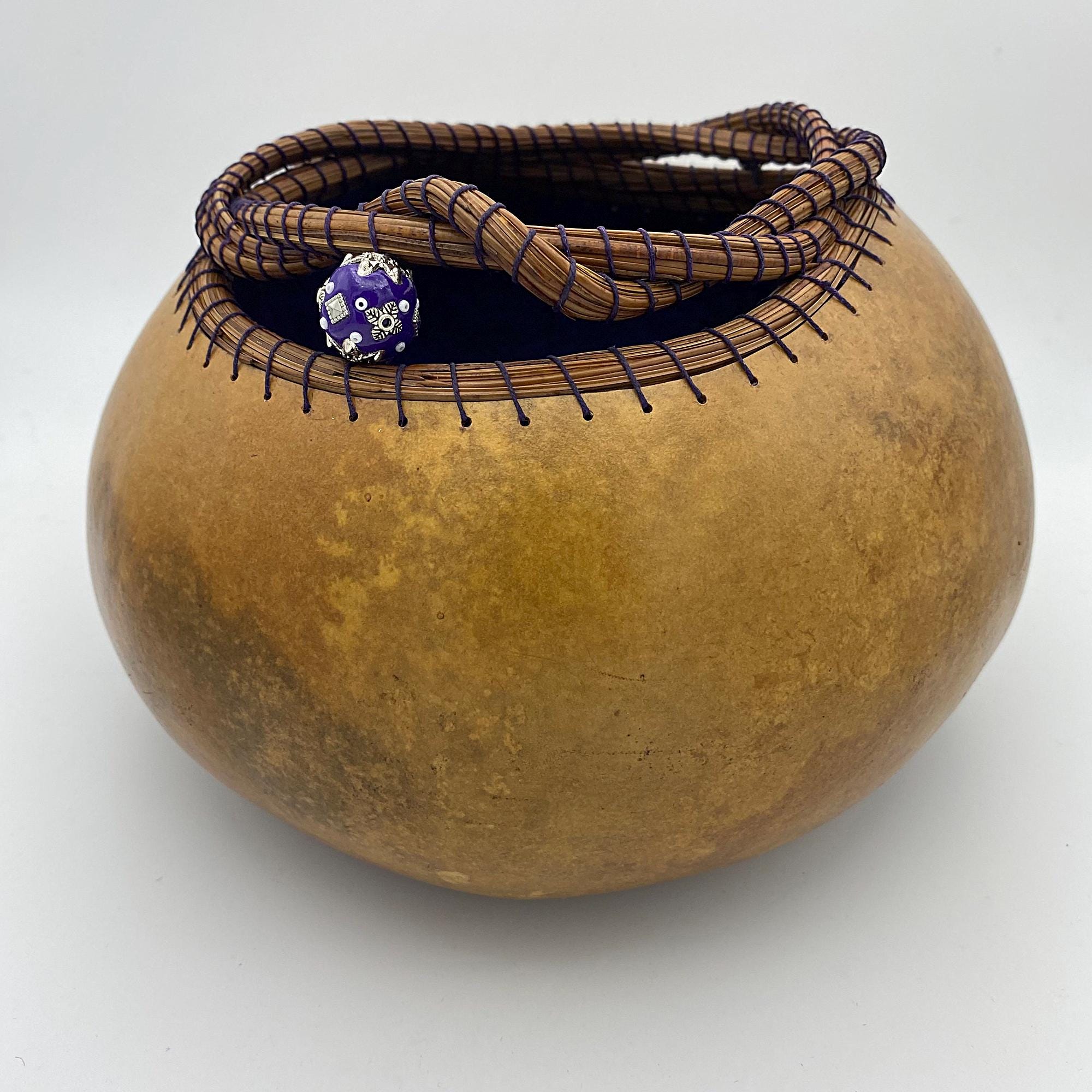Gourd vessel dyed with a twisty pine needle rows on rim. Beads added.