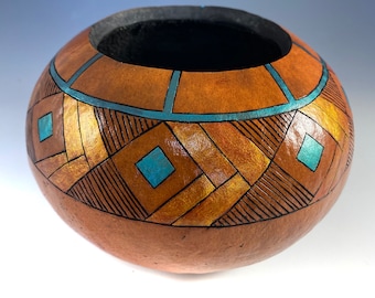 Gourd art vessel dyed with burned and dyed in geometric pattern.