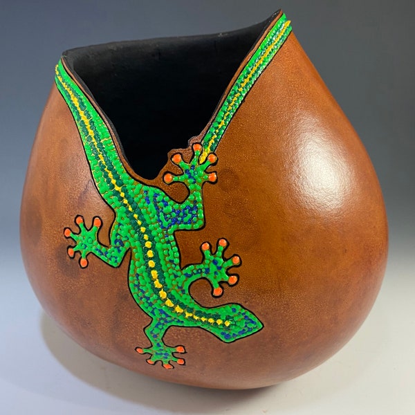 Gourd art vessel dyed with burned and puff paint added in a gecko motif.