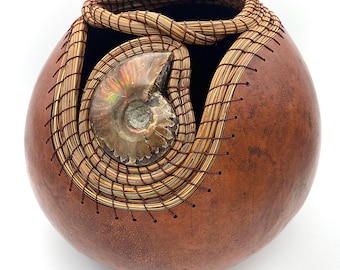 Gourd vessel with a fire ammonite woven with pine needles.